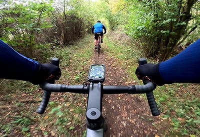 Taken from the perspective of the cyclist, a view over the handlebars